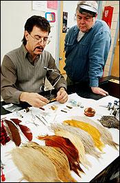 Sam Vigorita, an instructor with the Main Line Fly-Tyers, shows James Nickerson some advanced techniques. Feathers and other materials mimic bugs, leeches, crayfish or other creatures fish might feed on.
